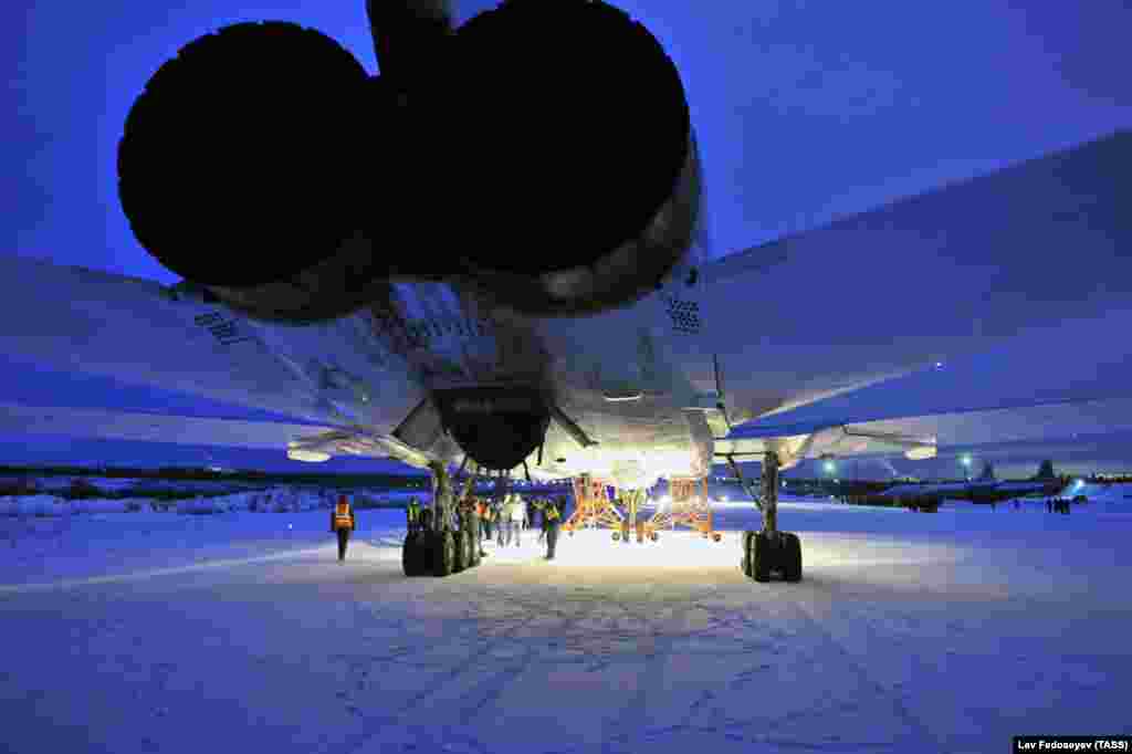 A Tupolev Tu-22M3 bomber lands at the Olenya air base near the town of Olenegorsk on December 11. Russian President Vladimir Putin ordered the start of a partial withdrawal of Russian forces two years after Moscow launched a campaign of air strikes in support of the government of Syrian President Bashar al-Assad and stepped up its military involvement on the ground. (TASS/Lev Fedoseyev) 