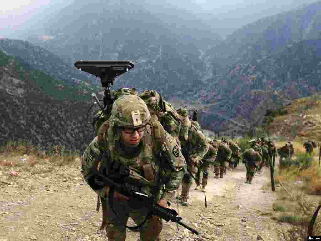 U.S. Army soldiers climb upon arrival to Observation Post Mace from Forward Operating Base Bostick in Afghanistan's eastern Naray district on August 26. Photo by Nikola Solic for Reuters