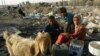 Children fill water containers at a garbage dump in Baghdad.