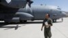 An Afghan Air Force pilot checks a C-130 military transport plane before a flight in Kabul in July.