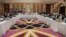 Qatari officials (center) take part in a meeting between U.S. special envoy Zalmay Khalilzad (second from left) and the U.S. delegation, and Sher Mohammad Abbas Stanikzai (sixth from the right) and the Taliban delegation, in Doha on February 26.