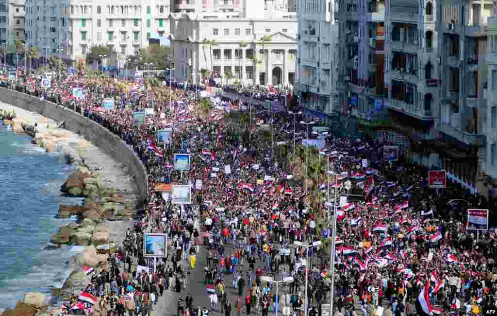 Antigovernment protesters march in the coastal city of Alexandria on February 11, 2011.