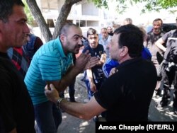 Tensions rose on April 25 between men who were blocking a road in Yerevan. Some appeared to be demanding a small number of cars be let through, while others wanted the road closed completely.