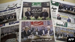 Iranian newspapers feature Iranian President Hassan Rohani and U.S. President Barack Obama, as well as Iranian Foreign Minister Mohammad Javad Zarif meeting his U.S. counterpart John Kerry on September 28.