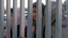 File - Female Iranian football fans watching from a distance as the Iranian national football team trains in Tehran.