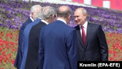 Russian President Vladimir Putin (right) speaks during a the medal ceremony in Moscow on June 12.