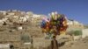 An Afghan man holds balloons for sale in Kabul. (Mohammad Ismail for Reuters)