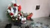 Portraits of TV cameraman Lekso Lashkarava are placed next to a broken camera during his funeral in Tbilisi on July 13.