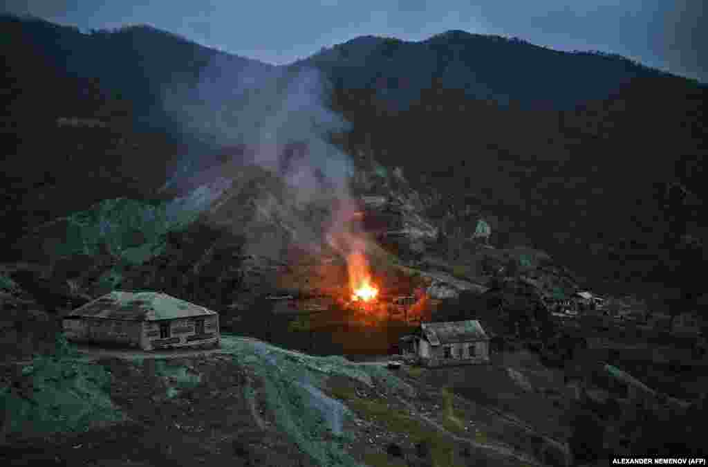 A house burns into the night in the district of Karvachar/Kalbacar.