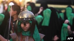 Iraqi Shi'a perform a reenactment of the Battle of Karbala in Baghdad as part of a parade in preparation for Ashura.