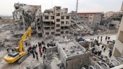 People gather at the site of an air strike in Tehran on March 12.