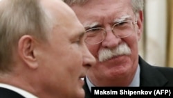 Russian President Vladimir Putin (left) attends a meeting with U.S. national-security adviser John Bolton at the Kremlin on October 23.