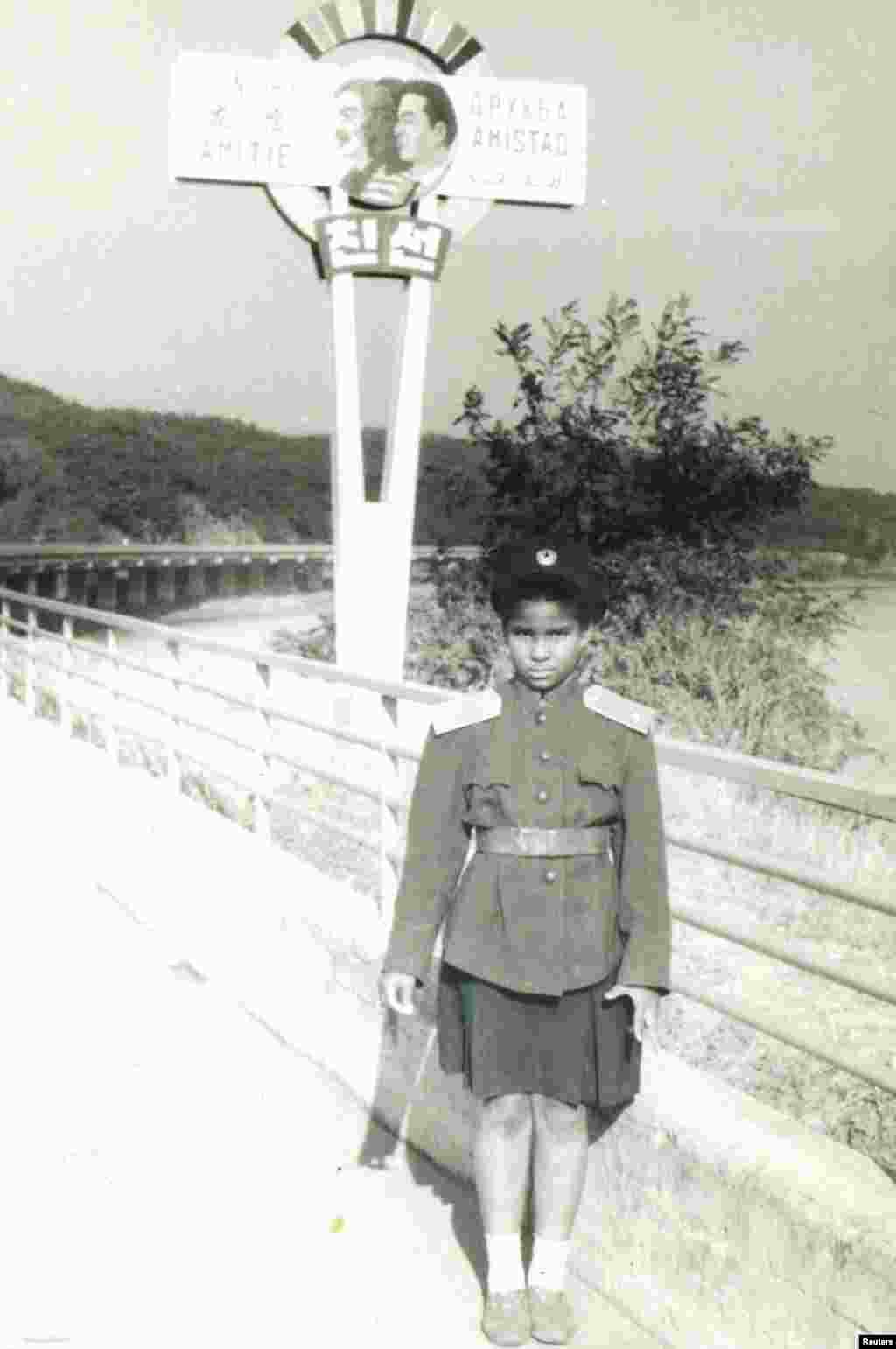 Macias in front of a sign reading "Friendship" on the Pyongyang-Nampho highway near her Pyongyang school in 1982.