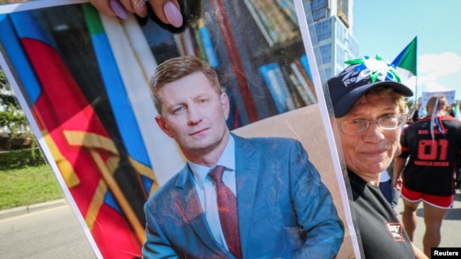 A protester holds up a picture of Sergei Furgal, the former governor, at a march in Khabarovsk on September 5.