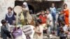 Displaced Iraqi children fill containers with dirty water in a neighborhood in eastern Baghdad. (file photo)