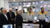 Iranian President Hassan Rouhani (3rd from L) and Iran's Atomic Energy Agency chief Ali Akbar Salehi (2nd from L) visit the control room of the Bushehr nuclear power plant in Bushehr, January 13, 2015