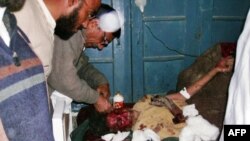 A Pakistani paramedic gives treatment to an injured suicide blast victim at a hospital in Lakki Marwat today.