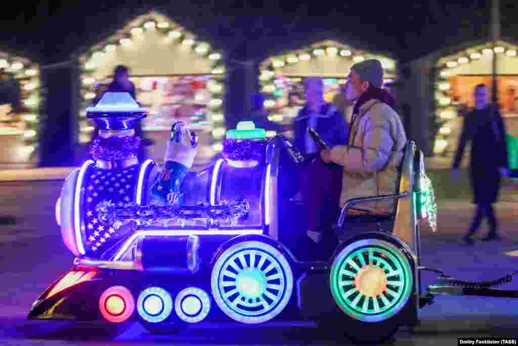 A man drives an illuminated mini-train in the seaside resort of Sochi on December 15.