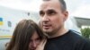 Ukrainian film director Oleh Sentsov hugs his daughter Alina Sentsova upon arrival in Kyiv after the Russia-Ukraine prisoner swap on September 7.