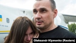 Ukrainian film director Oleh Sentsov hugs his daughter Alina Sentsova upon arrival in Kyiv after the Russia-Ukraine prisoner swap on September 7.