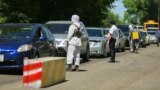 Kyrgyzstan - Bishkek - life in the city after quarantine - roads - people - street - parks a man in protective uniform checks the driver on the road to Bishkek12 May 2020