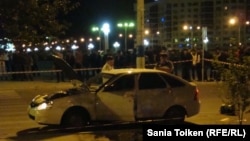 Police inspect a car near the scene of the September 15 incident.