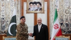 Iranian Parliament speaker Mohammad Baqer Qalibaf (right) shakes hands with Pakistan's army chief Asim Munir before their meeting in Tehran on April 16.