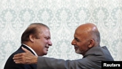 Afghan President Ashraf Ghani (R) embraces Pakistani Prime Minister Nawaz Sharif after a news conference in Kabul on May 12.