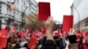 Demonstrators show symbolic red cards to Czech President Milos Zeman during a protest rally in Prague on November 17.