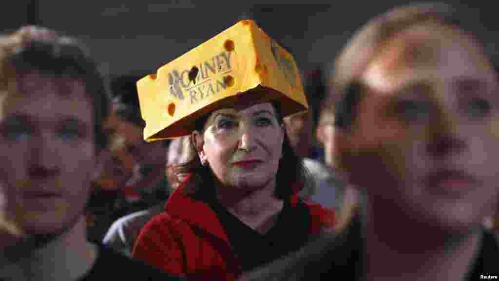 A woman wearing a Romney-Ryan "cheese head" hat listens as Republican presidential nominee Mitt Romney is introduced in West Allis, Wisconsin. (Reuters/Brian Snyder)