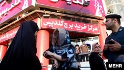 Tehran police round up women for their "inappropriate" dress in July 2012.