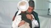 President Karzai embraces a man from Bala Buluk, where a U.S. air strike killed 140 civilians 