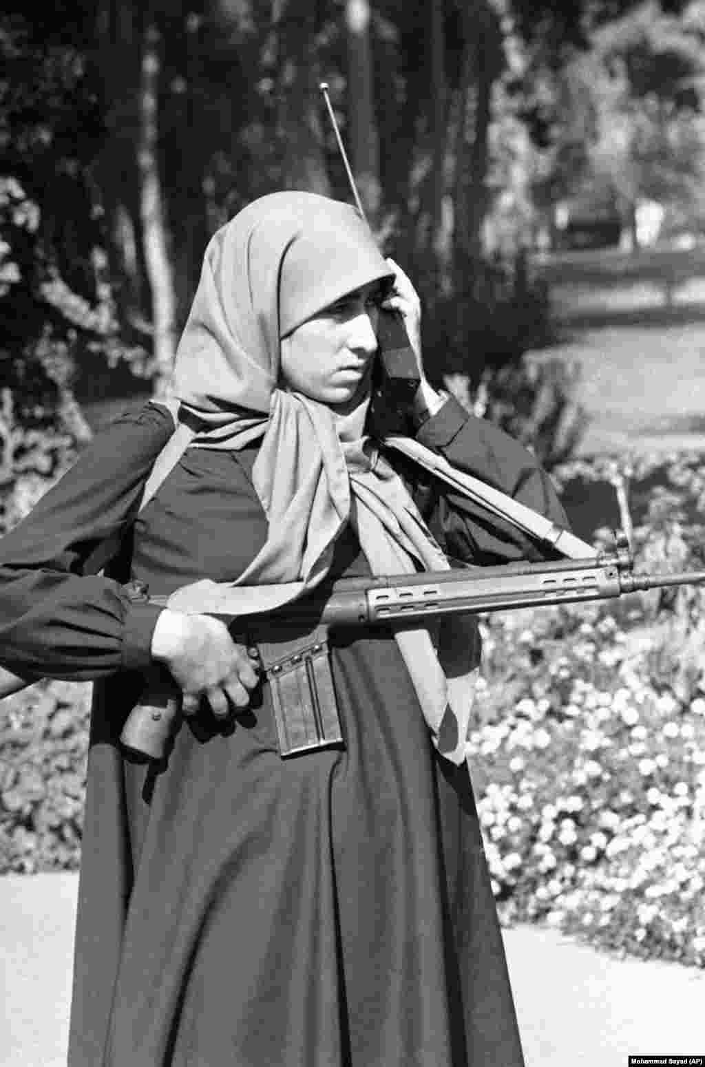 An Iranian student security guard patrols the embassy on November 10, 1979, as thousands of demonstrators gathered, chanting anti-American slogans. Leaders of the hostage-takers later said they never expected to hold the embassy for more than a few hours. They said they changed their plan after Ayatollah Khomeini endorsed their actions.