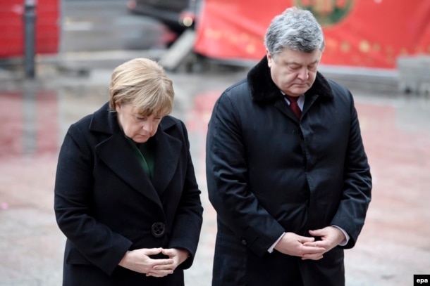 Ukrainian President Petro Poroshenko (right) cut short a visit with German Chancellor Angela Merkel to deal with the crisis in the east.