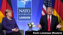 Amintiri din viitor: cancelarul german, Angela Merkel, îl ascultă pe Donald Trump la un summit NATO, în 2019. „I-am spus Angelei: Ne datorați bani!” - a rememorat recent momentul republicanul american. 