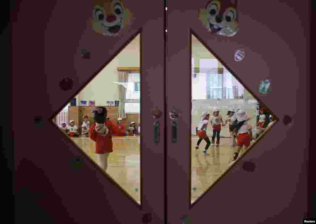 Children play dodgeball at their kindergarten.