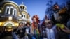 Children wait for the Holy Fire, a flame lit in Jerusalem and passed from candle to candle, to arrive at the Cathedral of St. Volodymyr in Kyiv.&nbsp;