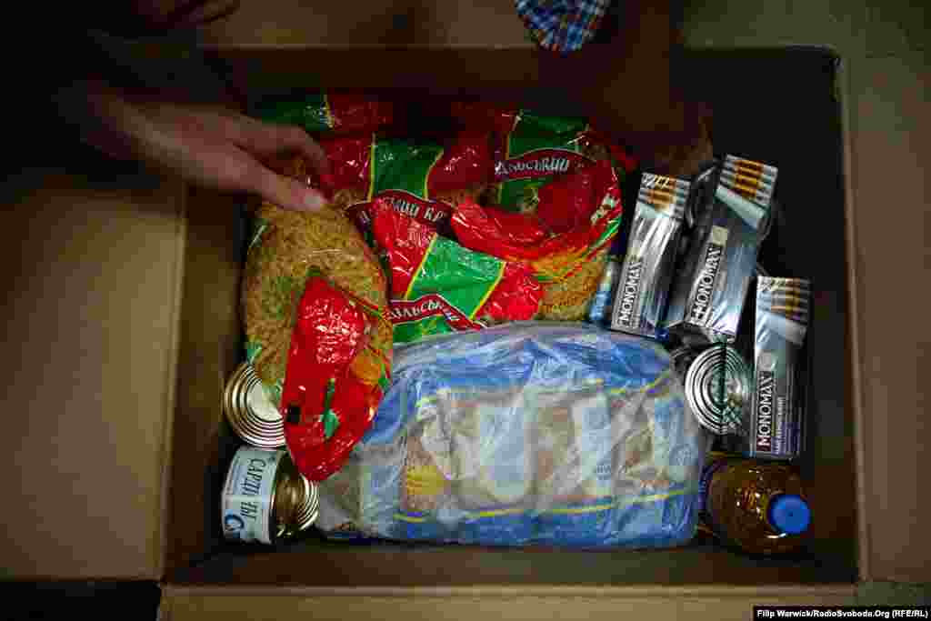 A typical monthly ration for one person from the World Food Program. The parcel weighs 21 kilograms and contains buckwheat, macaroni, kidney beans, canned meat, canned fish, sunflower oil, sugar, salt and tea.