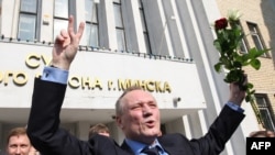 Former presidential candidate Uladzimer Nyaklyaeu raises his hands as he leaves the court building in Minsk on May 20.