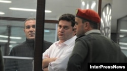 The arrest of Georgia's former Defense Minister Bacho Akhalaia (center) has given rise to speculation that a campaign is being waged against Prime Minister Bidzina Ivanishvili's political adversaries. 