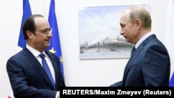 French President Francois Hollande (left) shakes hands with Russian President Vladimir Putin when the two met at Moscow's Vnukovo Airport on December 6.