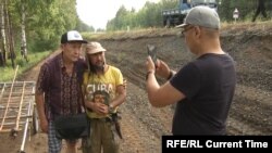 Aleksandr Gabyshev (center) walked hundreds of kilometers and spoke with hundreds of people along the way.