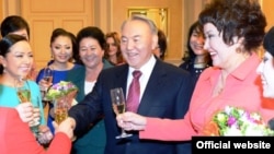 Kazakh President Nursultan Nazarbaev (center) made his remarks at a gathering of women assembled for International Women's Day on March 7. (file photo)