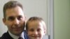 Pavel Astakhov, the Kremlin's ombudsman for children's rights, with Artyom Savelyev, who was adopted by a U.S. woman and sent alone on a flight back to Moscow