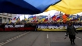 Ukrainian and Russian flags fly at a protest in Moscow against Russia's takeover of Crimea on March 15, 2014.