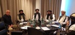 The strike came just hours after US special representative Zalmay Khalilzad (left) and senior Taliban officials spoke by phone with U.S. President Donald Trump on March 4.