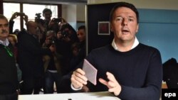 Italian Prime Minister Matteo Renzi casts his ballot in a polling station during the referendum on the government's constitutional reform in Pontassieve, near Florence, on December 4.