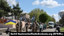 The funeral procession for brothers Oleh and Kostyantyn Zaliznyak passes through Petrove in Ukraine's central Kirovohrad region.