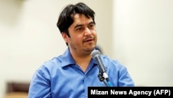 Ruhollah Zam speaks during his trial at Iran's Revolutionary Court in Tehran on June 30.