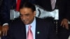 Pakistan's President Asif Ali Zardari signs a constitutional reform law during a ceremony in Islamabad.